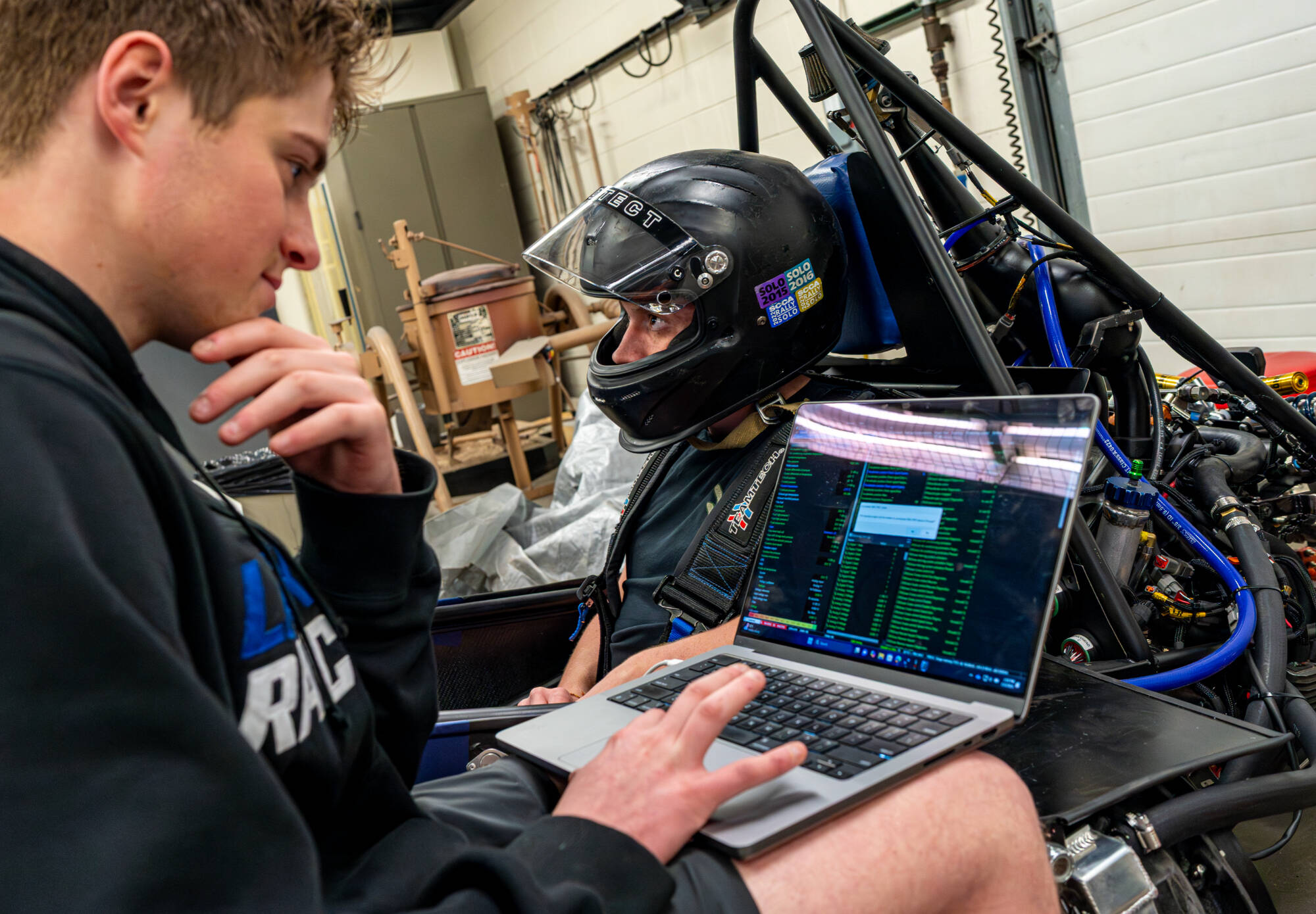 Members of the GVSU Formula SAE Racing Team mechanical engineering major Jace Kragt, left, and mechanical engineering major Ethan Whiting, work inside the vehicle bay at the Kennedy Hall of Engineering on the Pew Grand Rapids Campus on May 3. (Photo r...